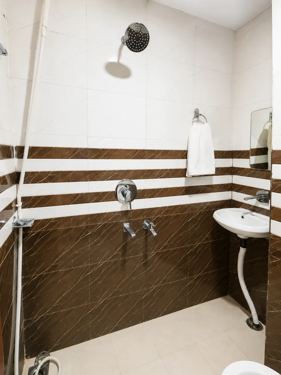 Attached bathroom with tiled walls
